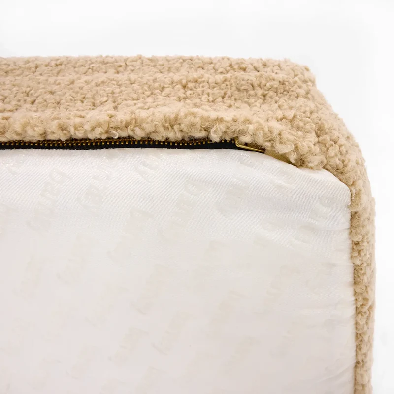 Teddy Cover in Rice Pudding: close-up of a corner, a brass zip joining beige teddy fleece to a white "barney" print.