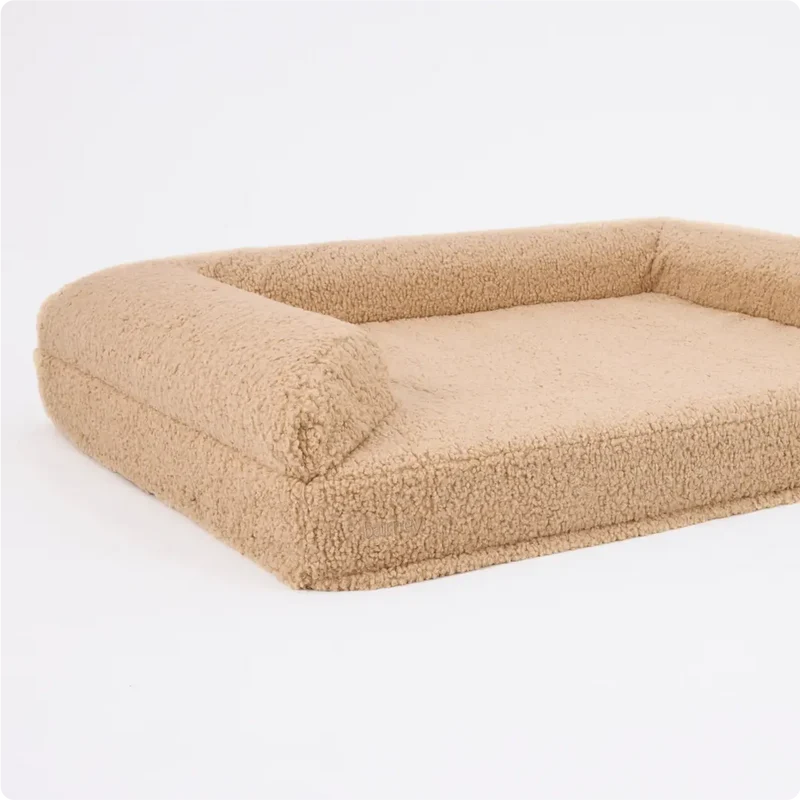 Arthur-Itis Cover in Rice Pudding: the bed on its own in oatmeal teddy fleece, bolsters on three sides and a low open front.