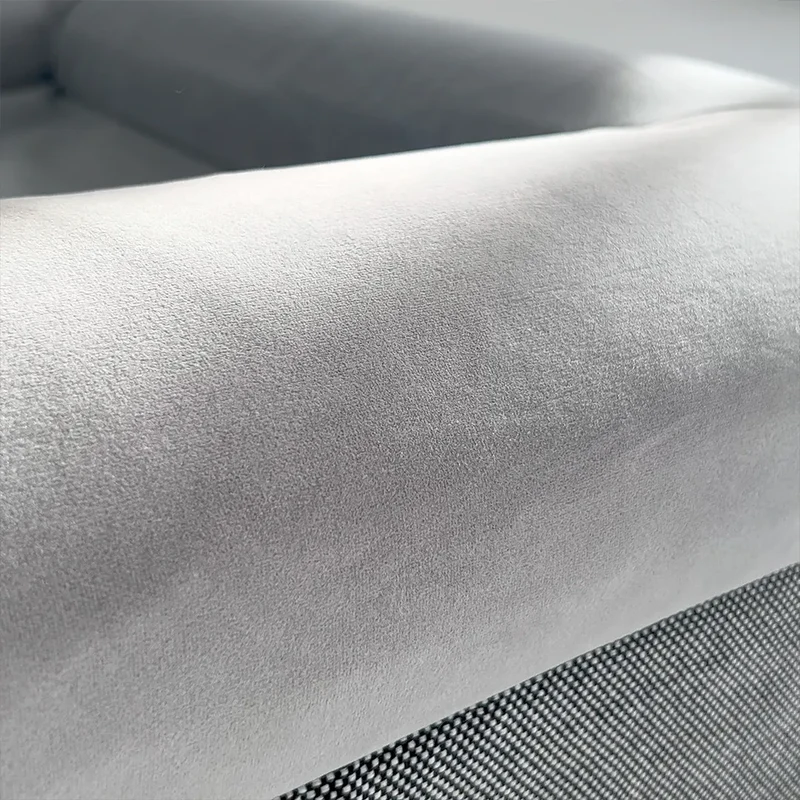 Close-up of a grey dog bed with soft fabric and sturdy construction.