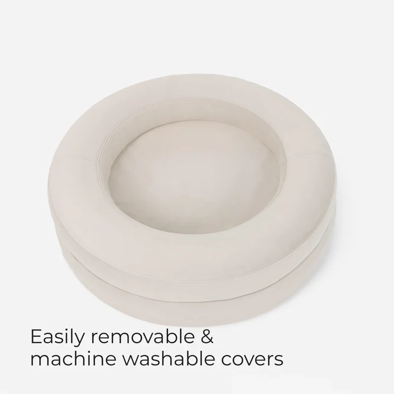 BarneyCurl Bed in Bone seen from above, with the words Easily removable & machine washable covers