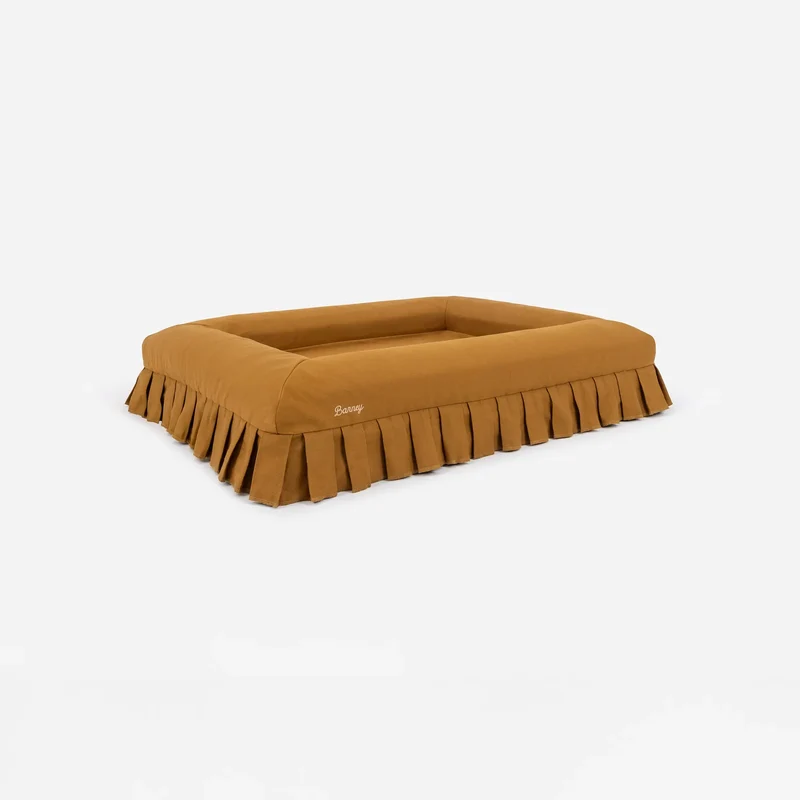 Nostalgia Cover in Toffee: the bed on its own from a corner, showing the pleated skirt on every side.