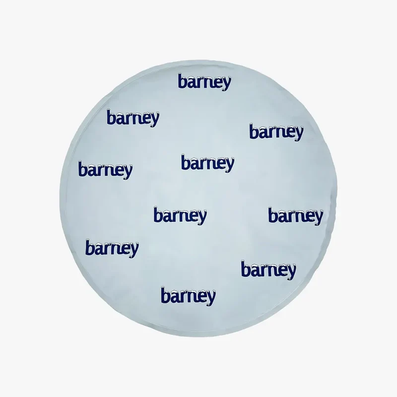 Barney Chill Pad, Curl: the round pale blue pad on its own, printed with navy "barney" logos topped with frost.