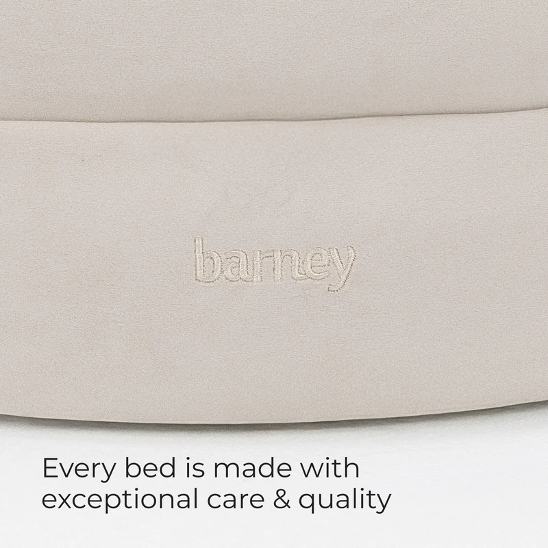 Barney logo on the side of a BarneyCurl Bed in Bone, with the words Every bed is made with exceptional care & quality