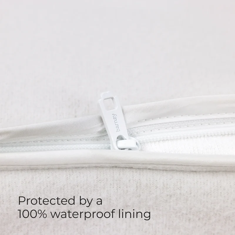 Zipper on the white inner lining of a Barney Bed, with the words Protected by a 100% waterproof lining