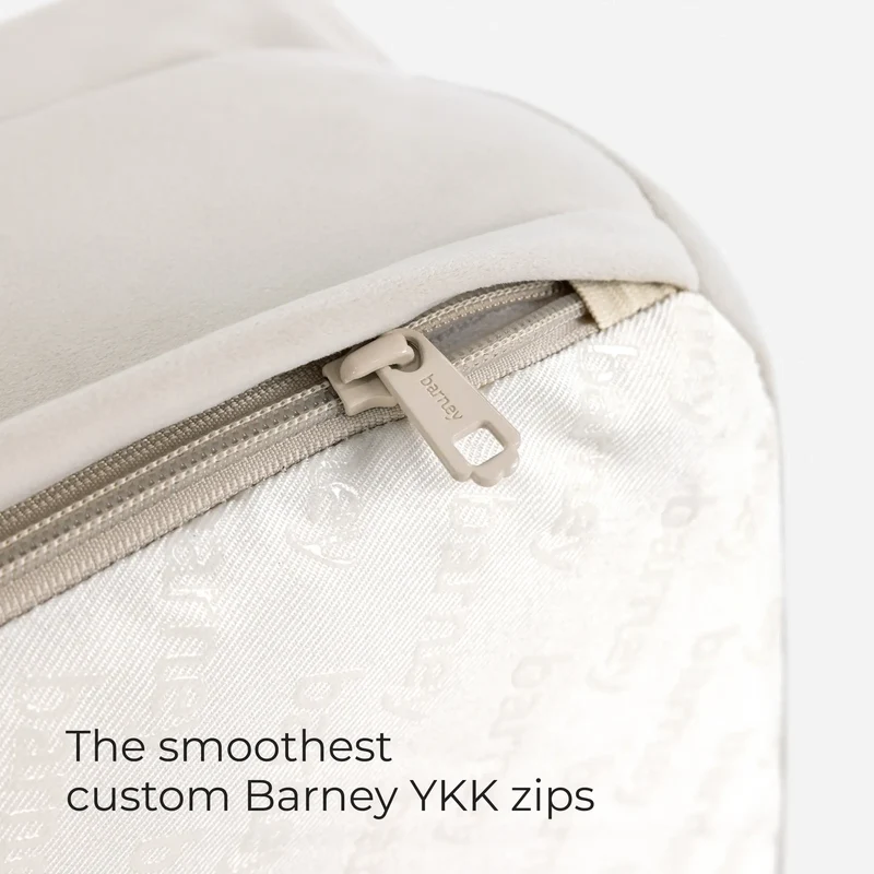 Close-up of the zipper on a Barney Bed in Bone, with the words The smoothest custom Barney YKK zips