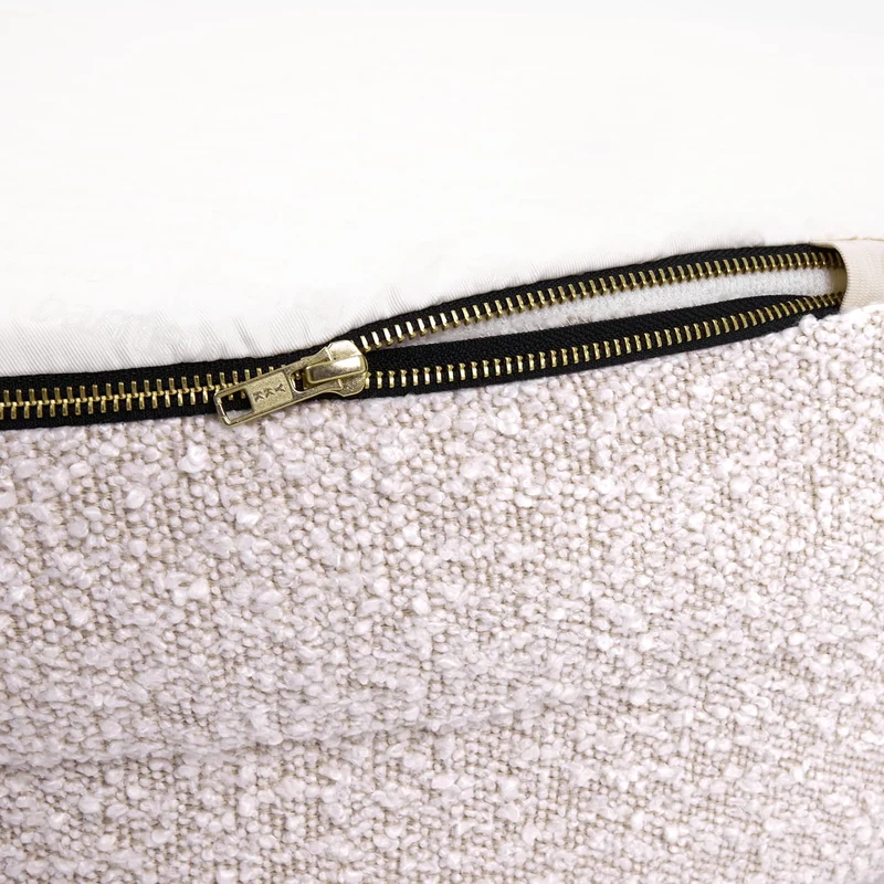 Close-up of a boucle dog bed with a visible zipper detail