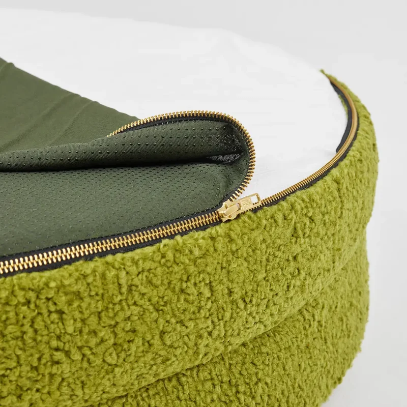 Teddy Cover Curl in Matcha: the gold zip opened around the green teddy rim, the dark green dotted base folded back.