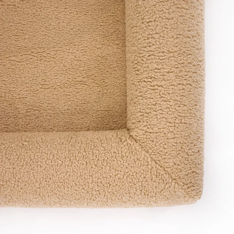 Teddy Cover in Rice Pudding on a Barney Bed: close-up of a corner from above, beige teddy fleece on the base and bolster.