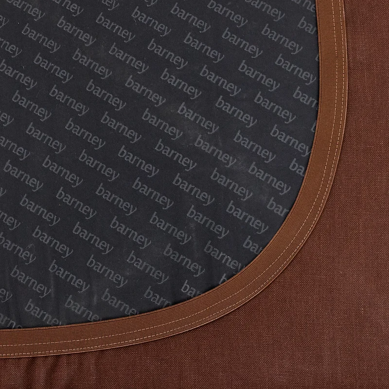 Close-up of a slip cover’s elastic band, stretched round the base of a bed