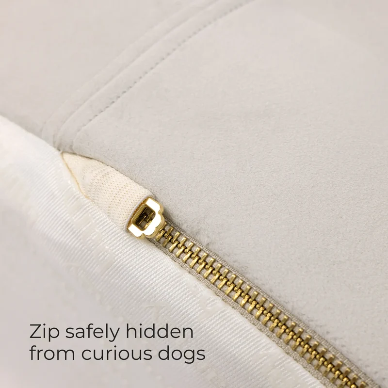 Gold zipper tucked under the cover of a BarneyCurl Bed, with the words Zip safely hidden from curious dogs
