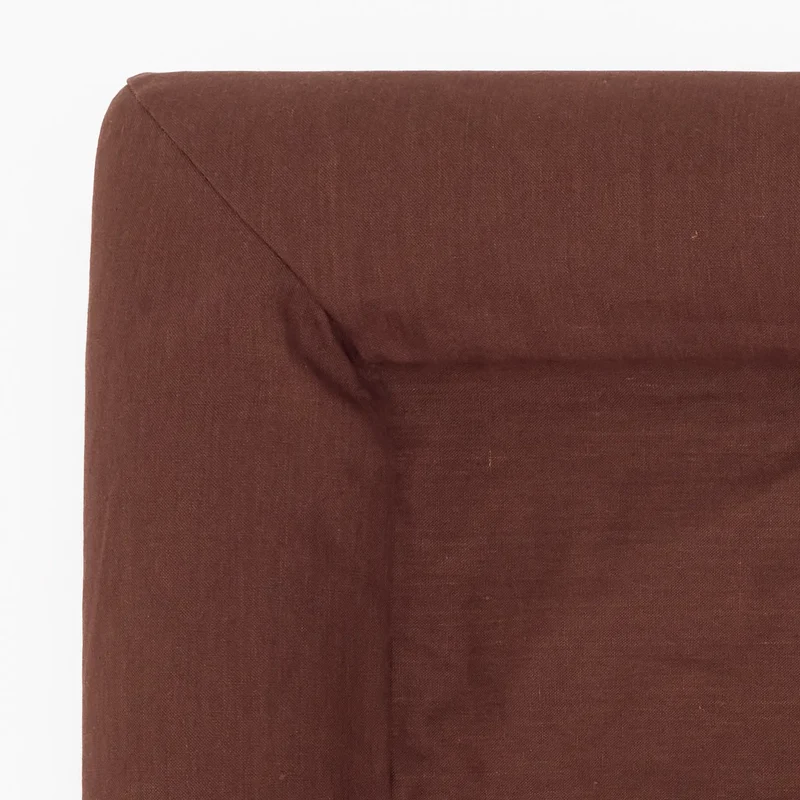 Linen Cover in Moose: close-up of a bolster corner from above, showing the chocolate brown linen weave and seams.