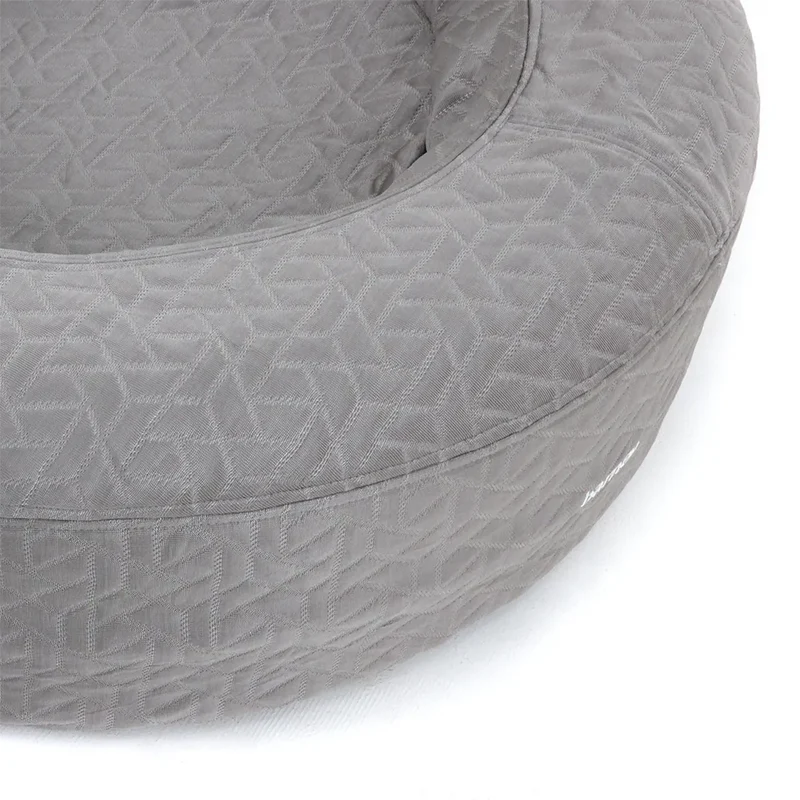 Grey round dog bed with textured fabric design