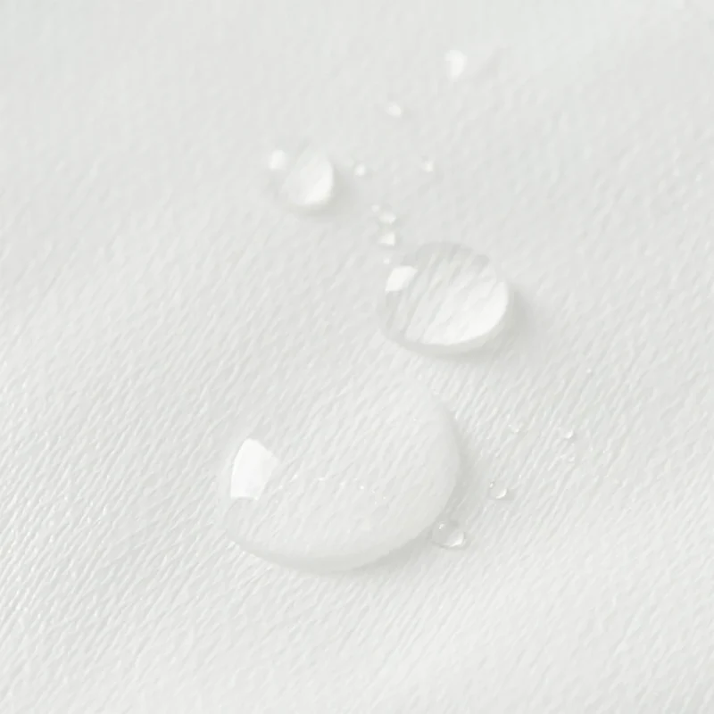 Waterproof Lining Kit: close-up of water droplets beading on the white lining fabric.