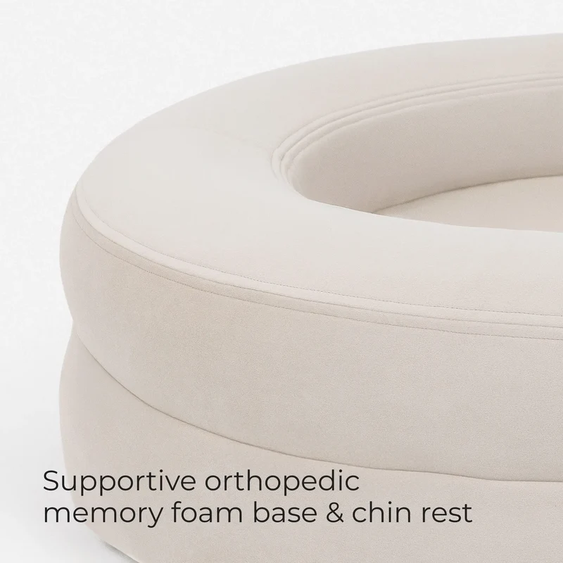 Close-up of the bolster of a BarneyCurl Bed in Bone, captioned supportive memory foam base and chin rest