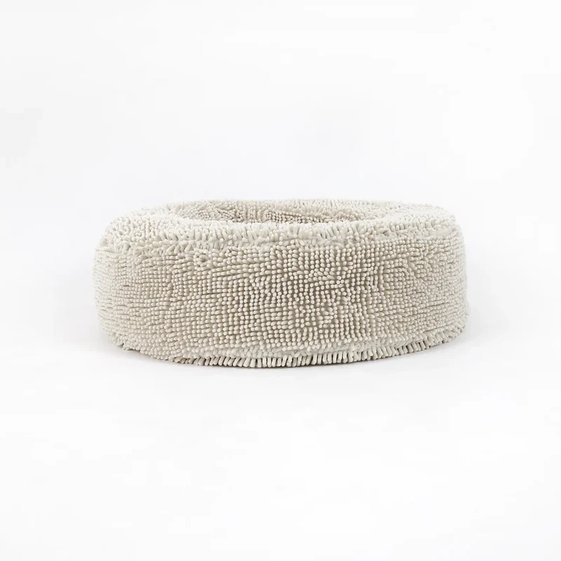 Barneycles Cover Curl in Sugarloaf: the round bed on its own from the side, covered in shaggy cream chenille, on white.