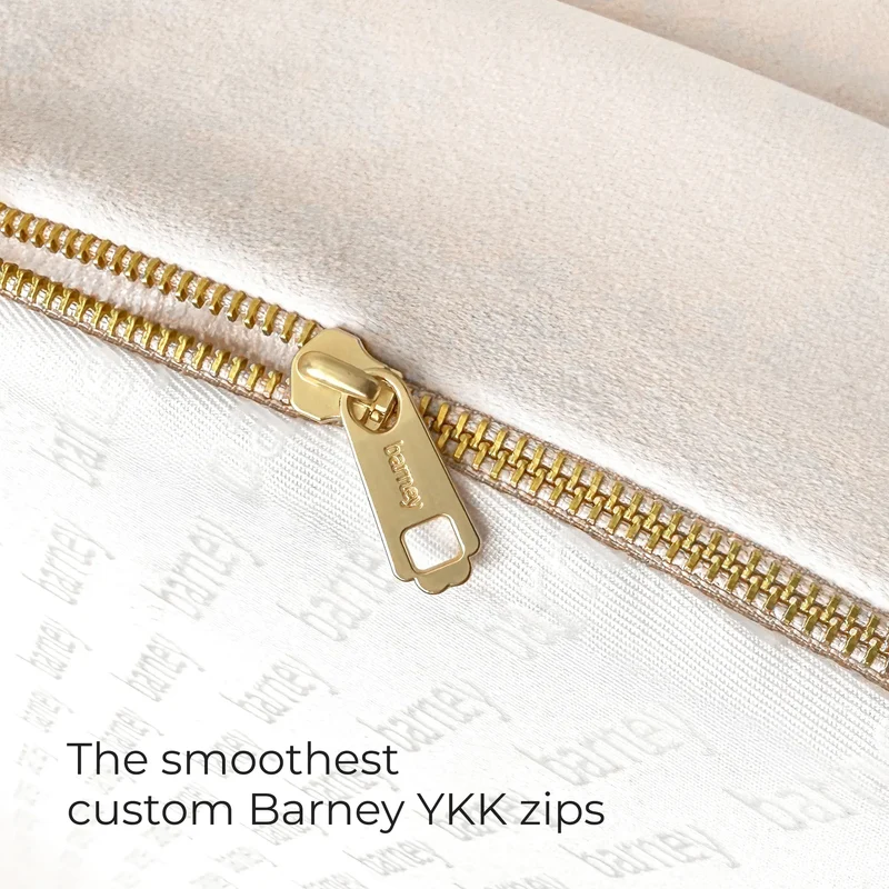 Gold zipper on a BarneyCurl Bed in Bone, with the words The smoothest custom Barney YKK zips