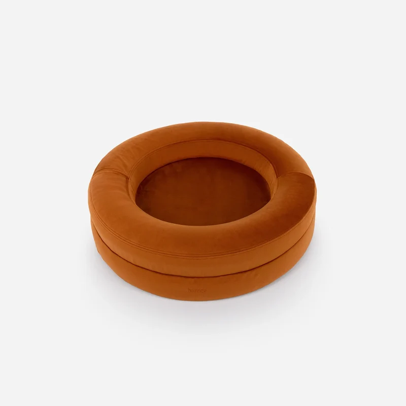 Velvet Cover Curl in Sunset on a BarneyCurl, from above at an angle: a burnt-orange velvet rim around the inner cushion.