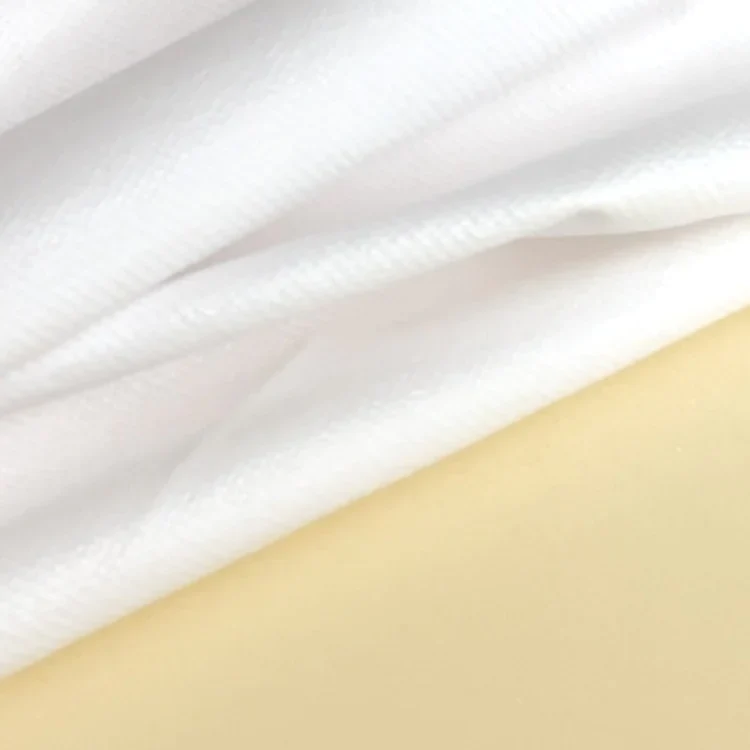Waterproof Lining Kit: close-up of the white lining fabric folded over the pale yellow foam of a bed.