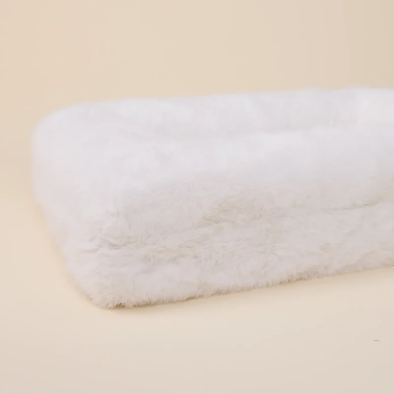 Fur Cover in Chibby: close-up of the side of the bed from an angle, showing the soft white faux fur.