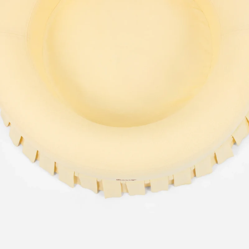 Nostalgia Cover Curl in Buttercream: the round bed from above, showing the pale yellow rim, inner cushion and pleated skirt.