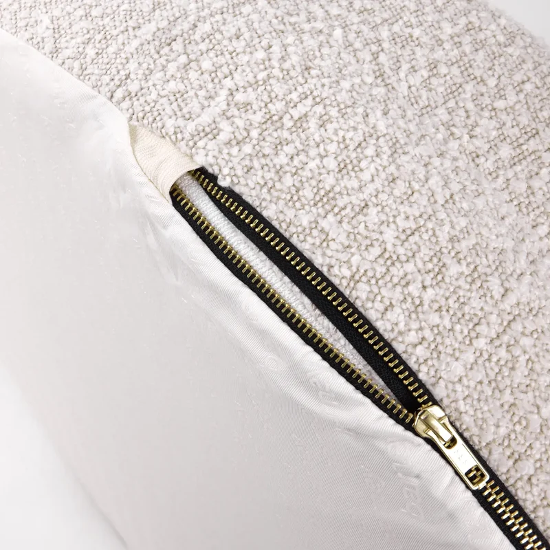 Close-up of the gold zipper on a Bouclé Cover Curl