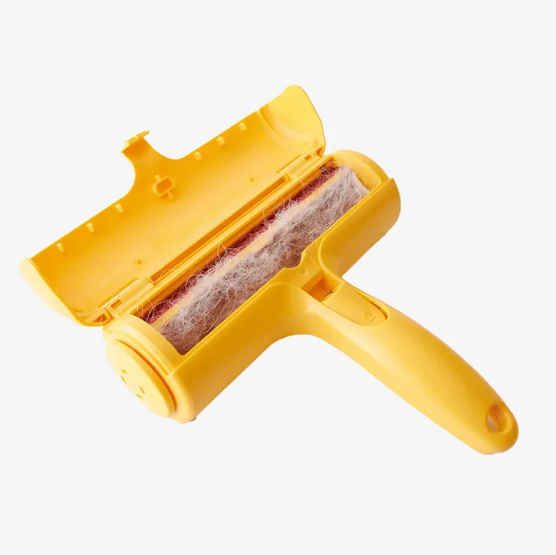 Furfy: the yellow roller with its lid open, showing the chamber full of collected pet hair.